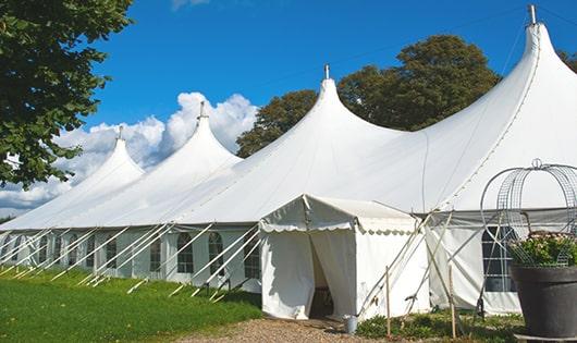 a line of sleek and modern portable toilets ready for use at an upscale corporate event in Gwinn